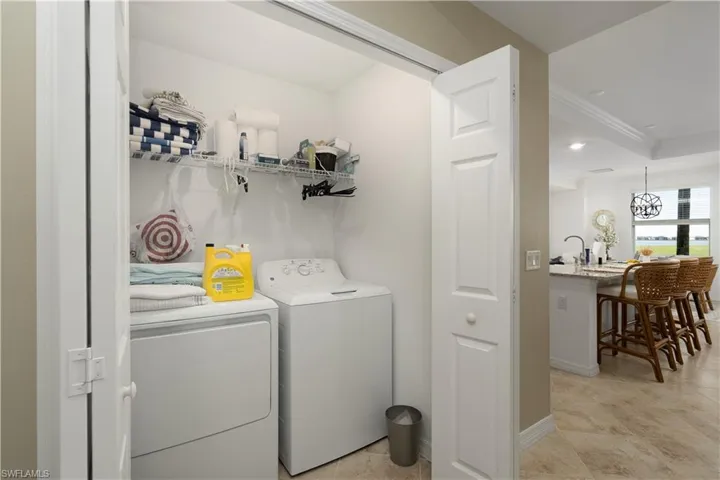 Laundry room featuring washer and dryer and ornamental molding