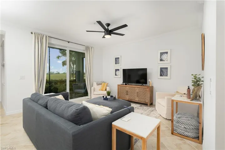 Living room with ceiling fan and crown molding