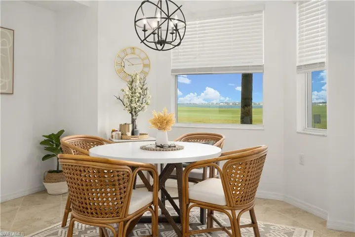 Dining space with a notable chandelier and light tile patterned flooring