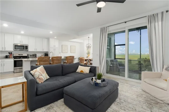 Living room featuring ceiling fan and crown molding