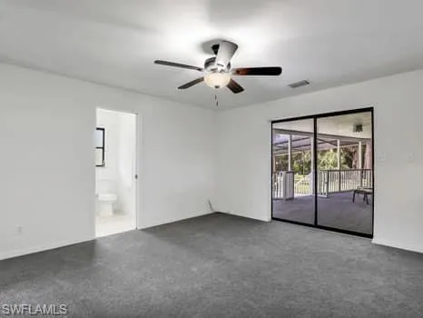 Empty room with ceiling fan and carpet flooring