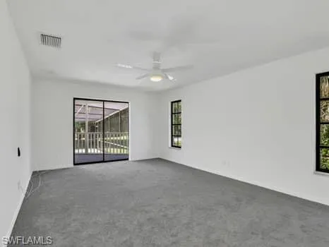 Unfurnished room featuring carpet floors and ceiling fan
