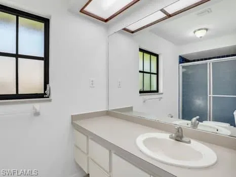 Full bathroom featuring vanity and an enclosed shower