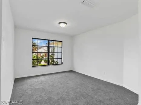 Unfurnished room with carpet flooring