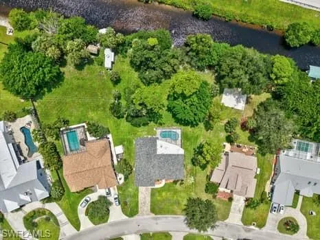 View of property location featuring a large body of water and nearby suburban area