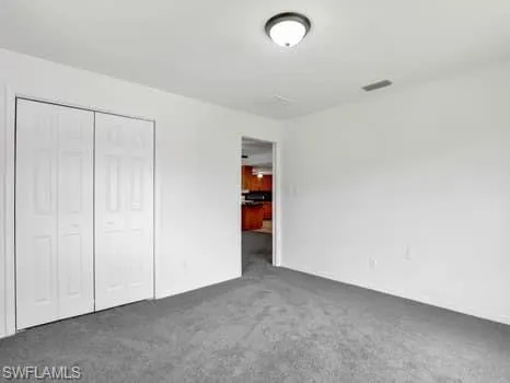Unfurnished bedroom with carpet floors and a closet