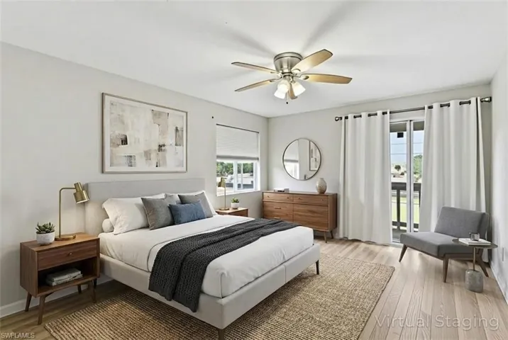 Bedroom with light wood-type flooring, access to outside, and a ceiling fan