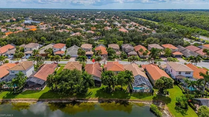 Aerial view of residential area featuring a nearby body of water