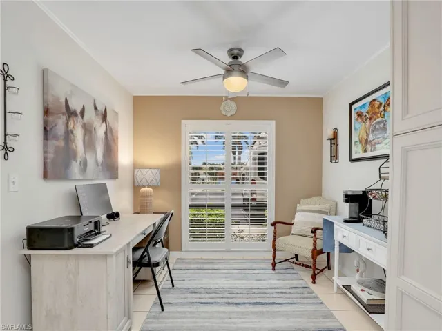 Office area featuring a ceiling fan, ornamental molding, and plantation shutters