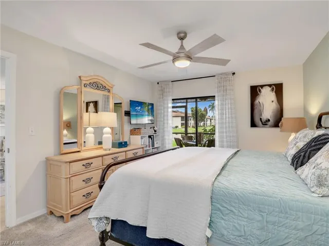 Bedroom featuring sliding glass doors w/ water views