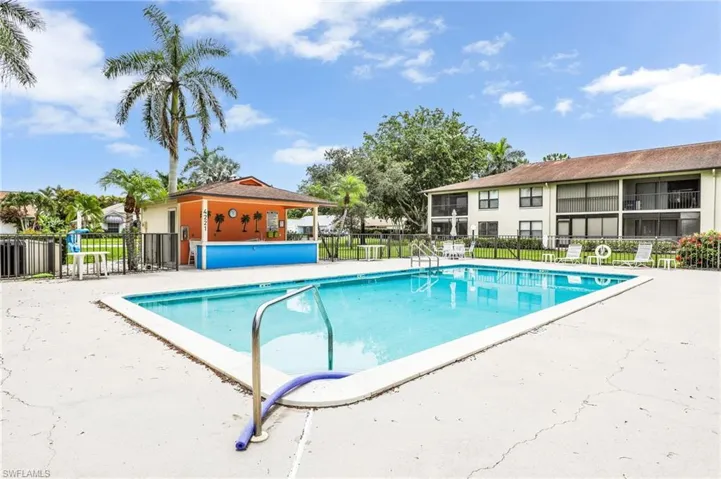 Community pool with a patio