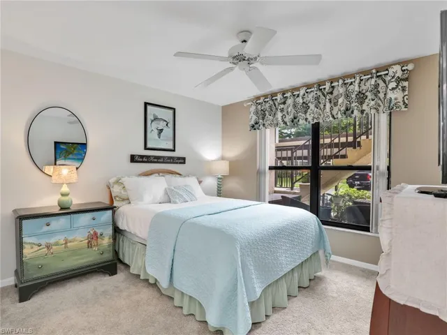 Bedroom featuring light colored carpet and a ceiling fan