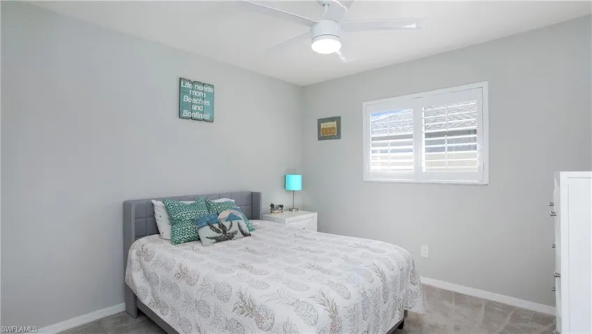 Bedroom with ceiling fan and carpet floors