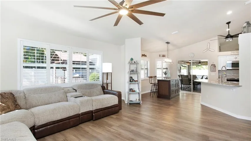 Living room featuring ceiling fan, hardwood / wood-style floors, and a wealth of natural light