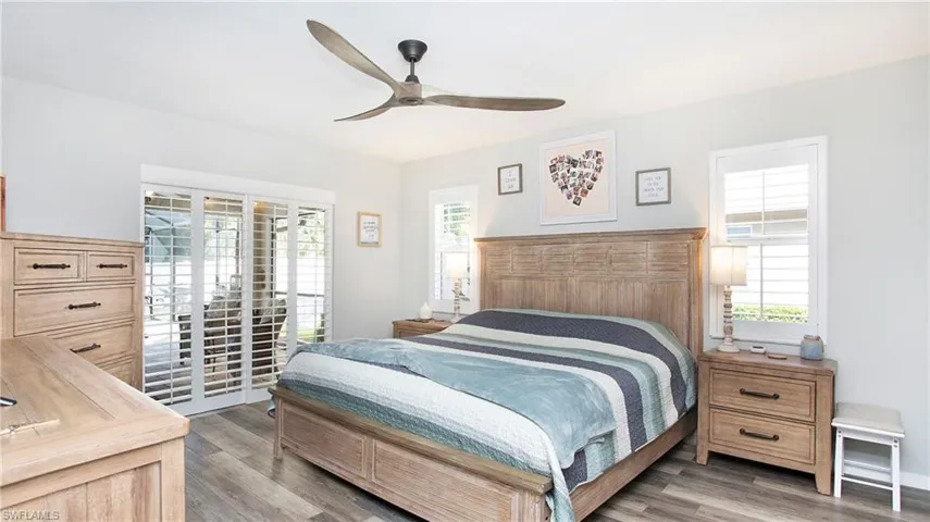 Bedroom with ceiling fan and hardwood / wood-style floors