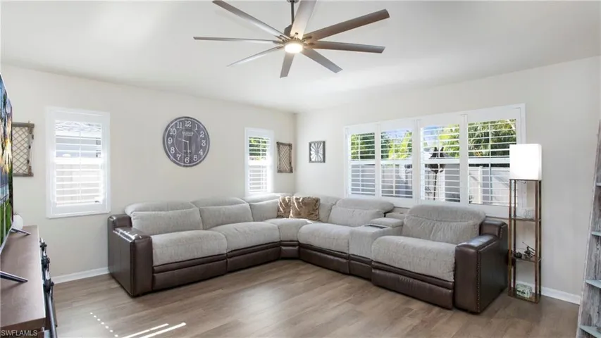Living room with wood-type flooring and ceiling fan