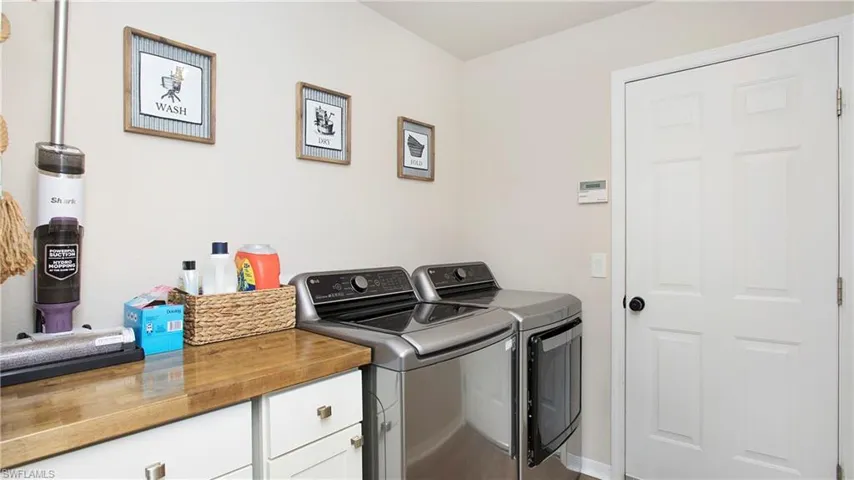 Laundry area featuring washer and dryer and cabinets
