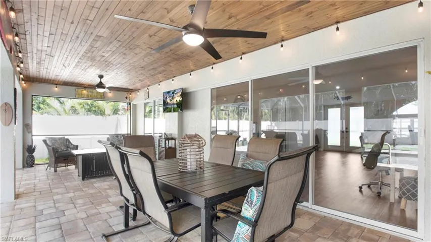 Dining space featuring tile floors, ceiling fan, french doors, and wooden ceiling