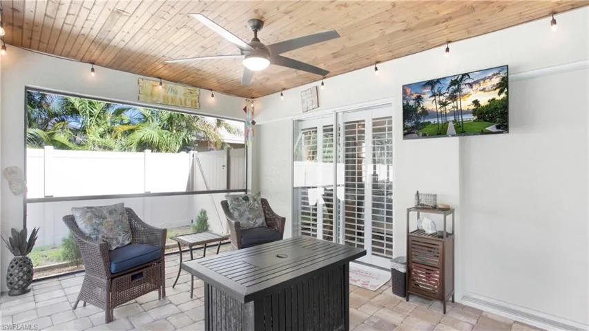 Sunroom / solarium with ceiling fan and wood ceiling