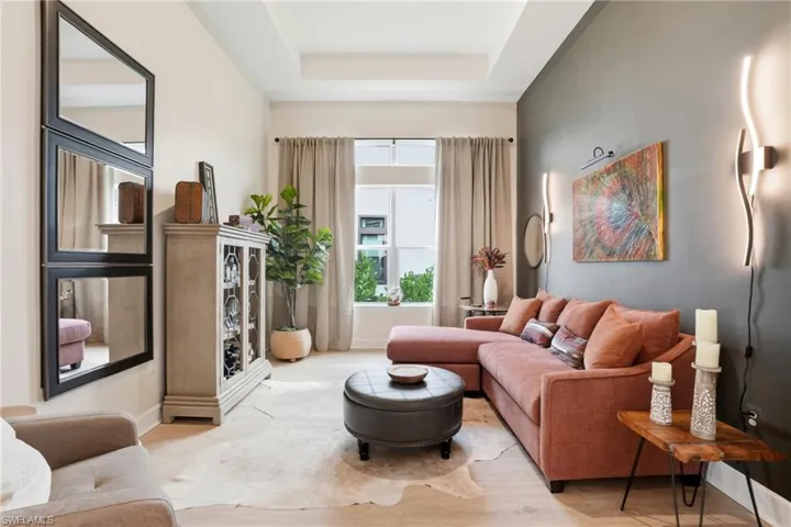 Living area with a raised ceiling and wood finished floors