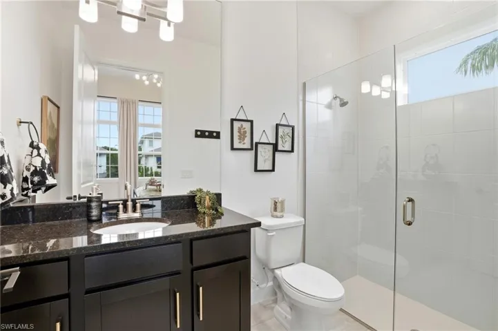Bathroom featuring a stall shower and vanity