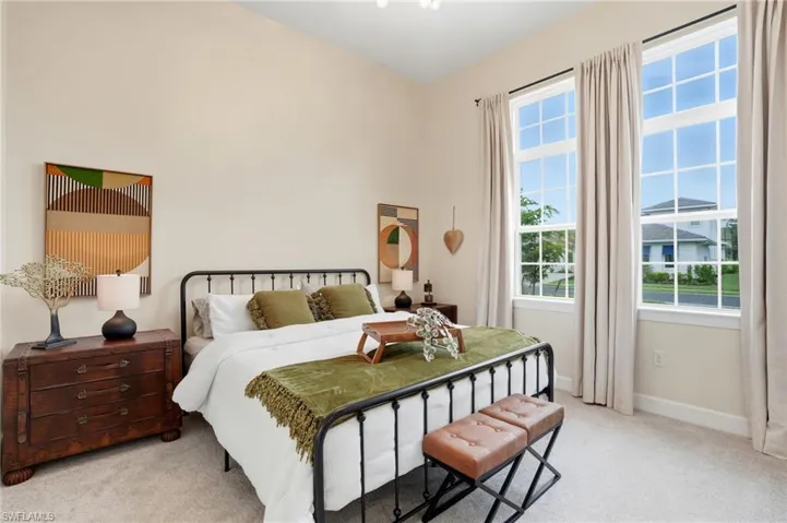 Bedroom with light carpet and baseboards