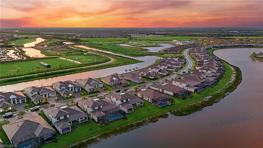 Aerial view at dusk of a water view and a residential view