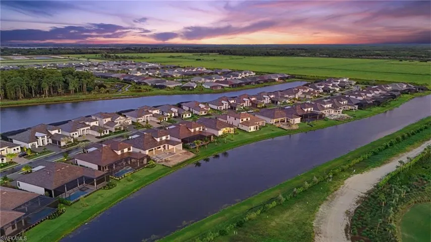 Aerial view at dusk of a water view and a residential view