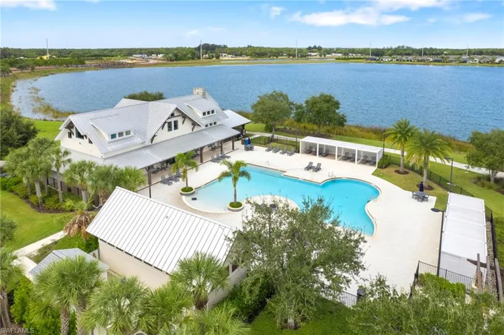 Expansive resort-style pool area featuring a free-form swimming pool, multiple shaded cabanas, and ample lounge space