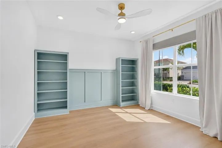 Built-in bookcase with glass French doors opening into the space