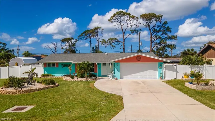 Vibrant ranch-style exterior with a contrasting turquoise and coral color palette