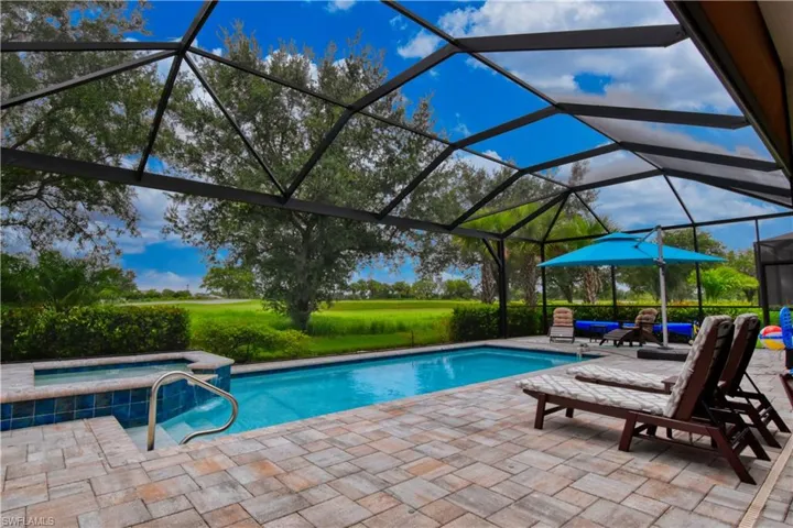 View of pool featuring an in ground hot tub, a patio, and a spacious lanai
