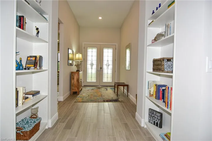 View of entry with built in bookshelves