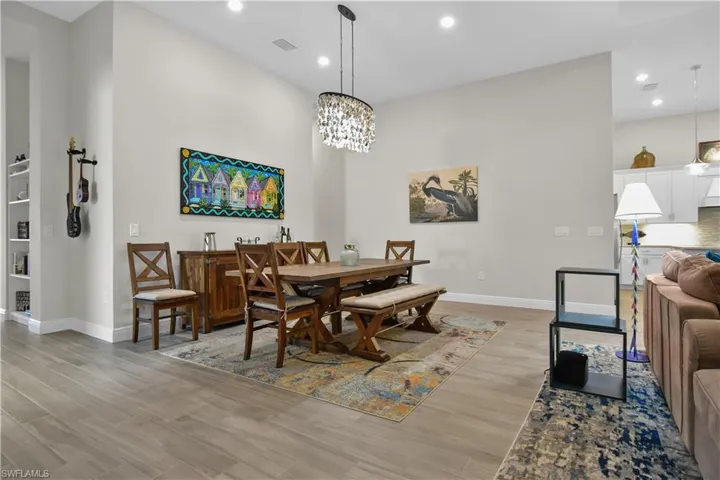Dining space featuring a notable chandelier and light hardwood / wood-style floors