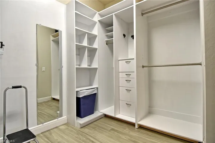 Walk in closet featuring custom shelving