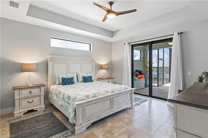A very spacious and private master retreat that is split from the other bedrooms and offers private access to the outside patio!  Detailed tray ceiling, neutral tile floors and a transom window to allow that  natural light in!