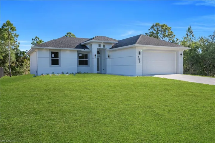 Contemporary single-story residence featuring a white stucco exterior