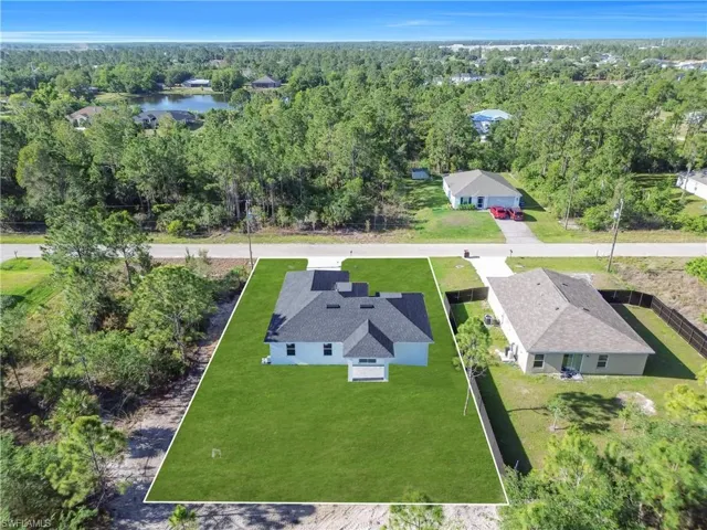 Newly constructed single-story residence featuring a dark shingle roof and light-colored siding