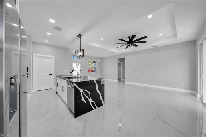 Open-concept living space with large format porcelain tile flooring