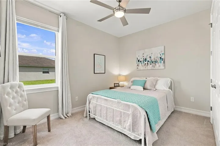 Guest bedroom with a ceiling fan and integrated lighting