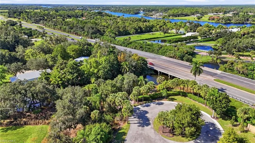 Aerial perspective of private boat ramp and dock with circular drive that leads to the Caloosahatchee River at the top and SWFL's waterways