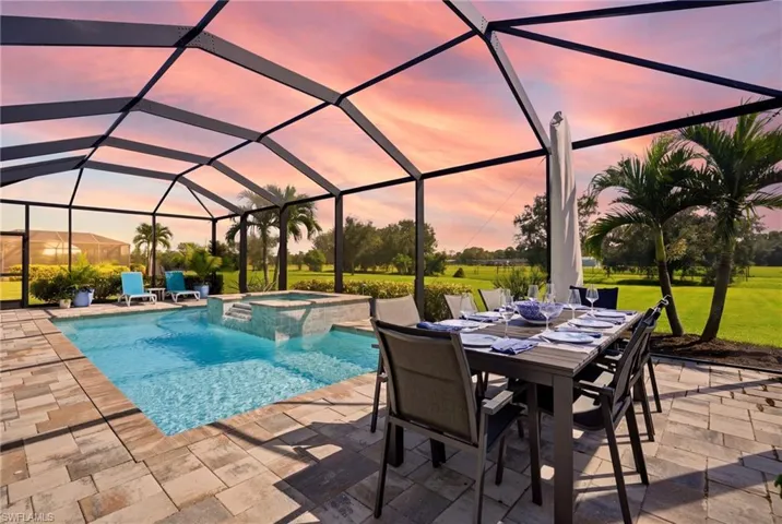 Spacious, screened outdoor living space featuring a salt water swimming pool, elevated spa with waterfall for relaxation and entertaining with panoramic landscape backdrop