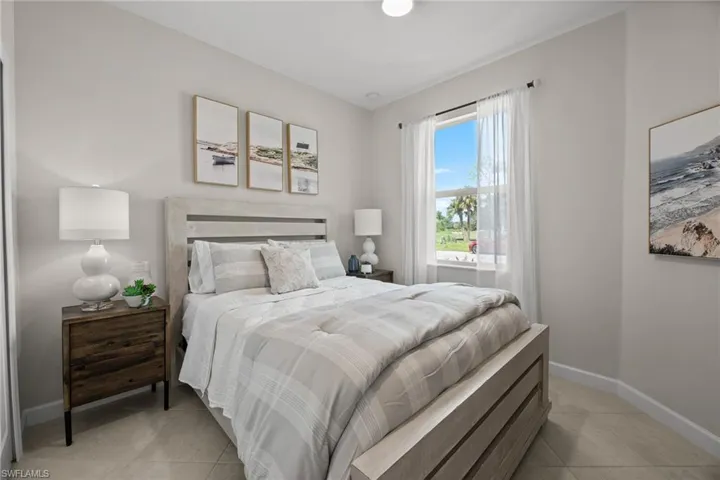 Bedroom with light tile patterned floors and baseboards