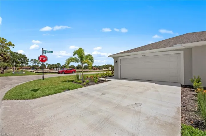 Garage featuring concrete driveway