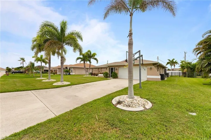 Ranch-style home with a garage, concrete driveway, and stucco siding