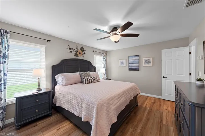 Bedroom with light wood-style floors and a ceiling fan