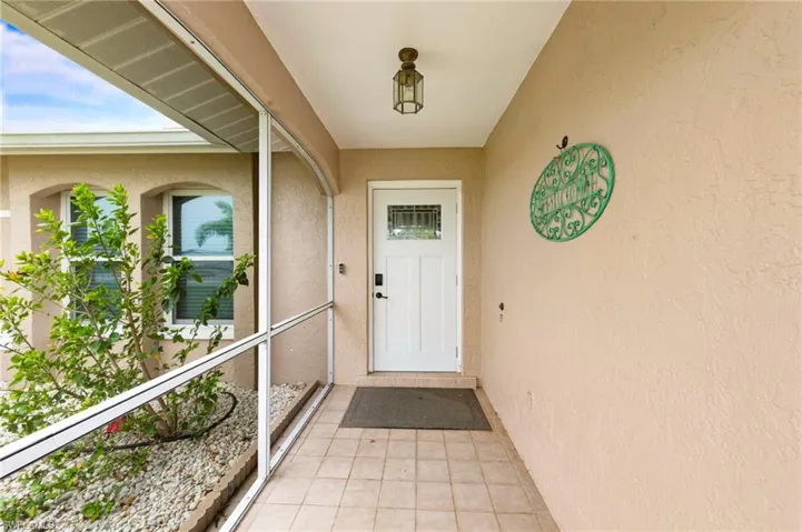Property entrance with stucco siding