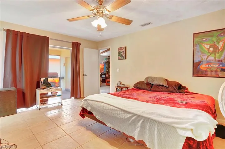 Bedroom with tile flooring and ceiling fan