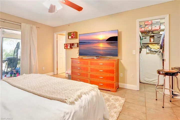 Bedroom featuring tile flooring, a closet, ceiling fan, and access to outside