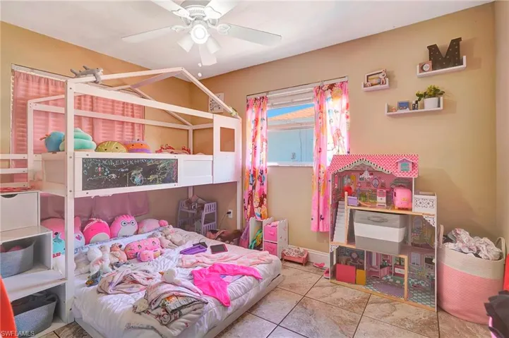 Bedroom featuring ceiling fan and tile floors
